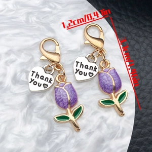 Detailed view of tulip pendants with Thank You heart charms and lobster clasps
