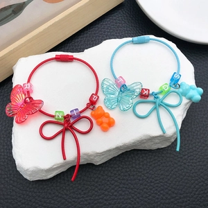 Detail of beaded resin bracelets with gummy bears and butterfly charms for kids