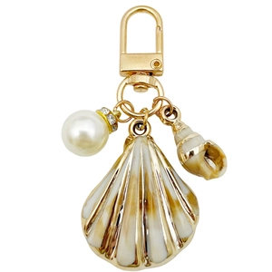 U-shaped golden keychain with acrylic ocean shell charms and a sparkling pearl detail
