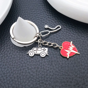 Antique silver medical keychain with stethoscope ambulance and red heart charms