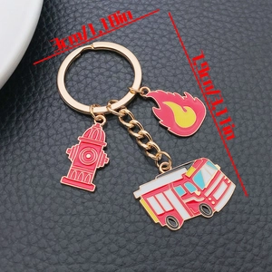 Detail of firefighter keychain with red fire hydrant, flame charm and red fire truck charms