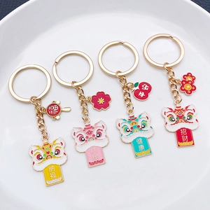 Close-up of four colorful lion dance keychains with traditional Chinese blessing tags