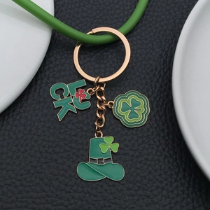 Green St. Patrick's Day keychain with Luck charm and clover hat on black leather