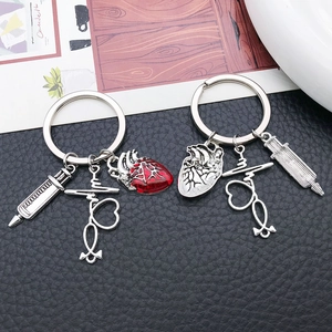 Creative medical keychain with silver syringe stethoscope and red anatomical heart charm