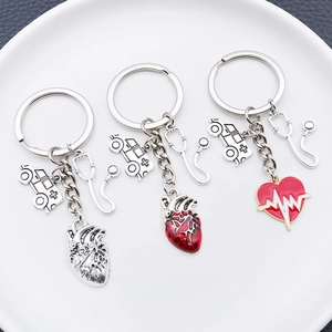Creative medical series keychain with syringe stethoscope and heart pendants in silver