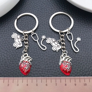 Antique silver medical keychain set featuring red heart, stethoscope and ambulance charms