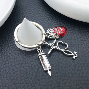 Creative medical keychain with silver syringe, red heart and ECG wave pendants