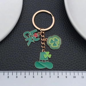 Luck clover keychain with green enamel shamrock and Irish hat on black background