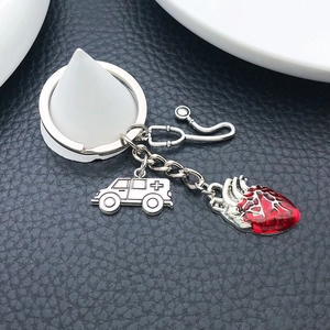 Antique silver stethoscope keychain with red anatomical heart and ambulance charms