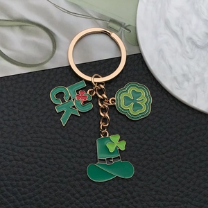 Detail of St. Patrick's Day keychain with luck clover and green hat enamel pendants