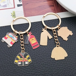Firefighter keychain set featuring red fire truck, extinguisher, and suit pendants