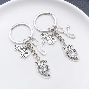 Detail shot of antique silver medical keychain with ambulance and heart charms