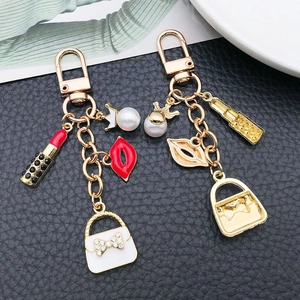 Fashion crown pearl and lipstick handbag keychain in gold alloy and white enamel