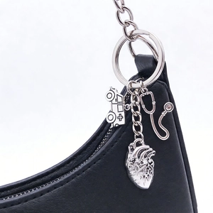 Close-up of stethoscope and heart charms on a medical-themed silver metal keychain