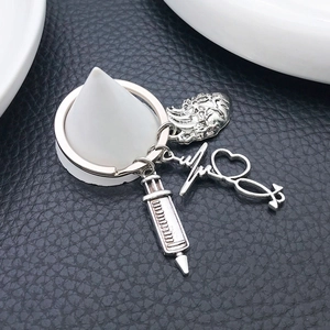Antique silver medical keychain with syringe, stethoscope and anatomical heart charms