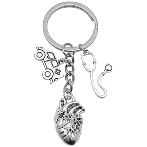 Vintage silver medical keychain with stethoscope, ambulance and heart charms on white background