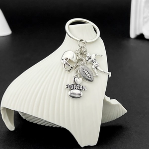 Detail of silver alloy football keychain with helmet, player, ball, and I love football tag