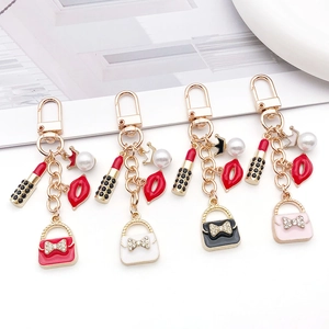 Set of 4 fashion keychains with crown pearls, lipstick, and red lips charms in 4 colors