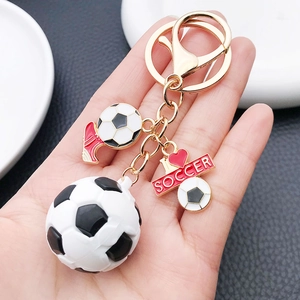 Detail of 3D soccer keychain featuring a mini football, red shoe, and I Love Soccer charm