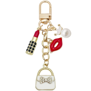 Golden keychain with lipstick, red lips, pearl handbag and crown charms for bags