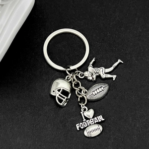 Vintage silver American football keychain with helmet, athlete, and ball charms