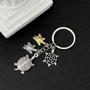 Ocean turtle keychain set with gold and silver sea turtle charms and nautical helm pendant