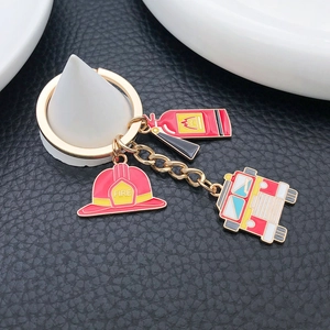 Firefighter themed keychain set with red helmet, extinguisher and truck charms