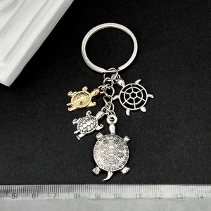Silver and gold turtle keychain with multiple sea turtle charms and 8-9cm length