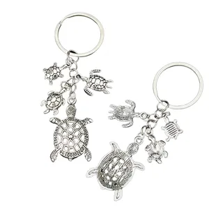 Antique silver sea turtle alloy keychain featuring one large and three small turtle charms