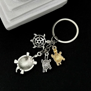 Vintage sea turtle keychain featuring turtle pendants and ship wheel on black background