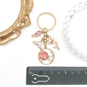 Pink enamel mermaid seahorse keychain with shell charms and golden hardware for bags