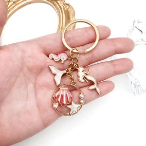 Pink ocean seashell keychain with seahorse mermaid charms and golden metal finish