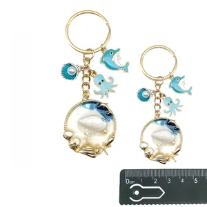 Portachiavi oceano blu con delfino polpo conchiglie e guida taglie righello