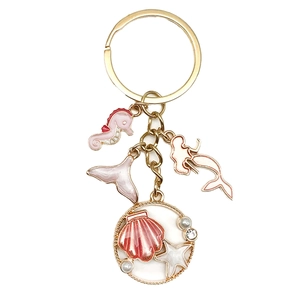 Pink ocean shell keychain with seahorse and mermaid charms in golden finish