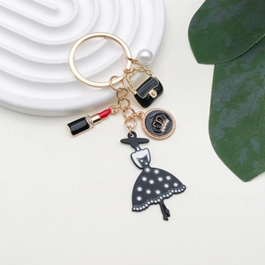 Chic keychain with lipstick, polka dot dress, pearl and handbag on gold alloy finish