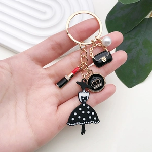 Fashionable keychain with black dress, lipstick, and pearl charms for women