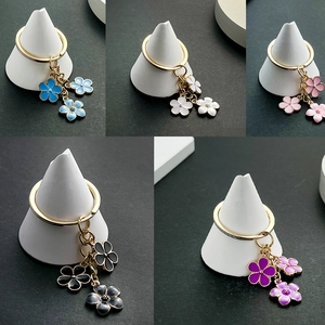 Porte-clés fleurs de cerisier en émail doré en cinq couleurs sur un présentoir