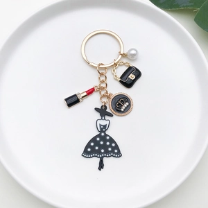 Detailed view of fashion keychain with lipstick, handbag, pearl and crown charms