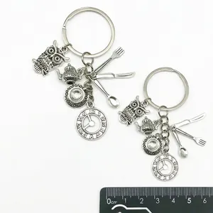 Vintage silver Alice in Wonderland keychain with owl, teapot, and clock charms