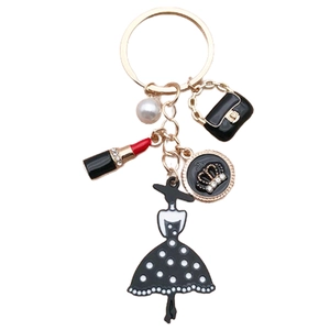 Elegant gold keychain with black handbag, pearl, lipstick, and lady silhouette charms