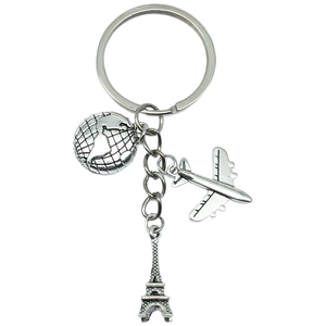 Travel keychain with silver globe, jet airplane, and Eiffel Tower pendants on white background