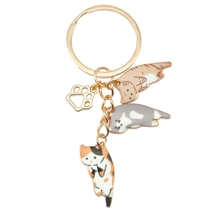 Cute golden cat keychain with enamel kittens and paw charms on white background