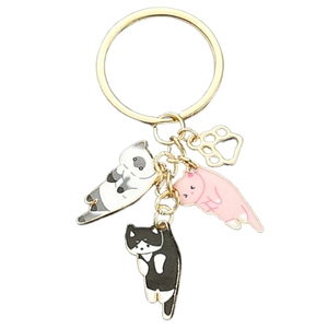 Cute cartoon oil-drop cat keychain with three kittens and hollow paw charm in gold