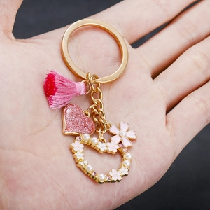 Handheld pink heart keychain with tassel, faux pearls and flower charms for bags