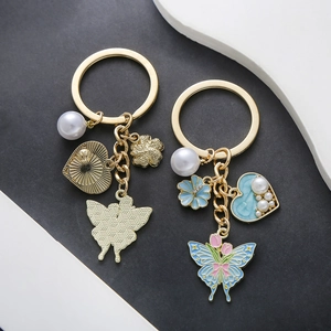 Blue heart and pearl keychain with rose butterfly charms on gold metal ring