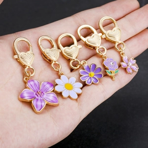 Detail of five lavender floral keychains with gold heart-shaped lobster clasps