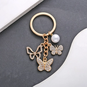 Goldener Schmetterling Künstliche Perle Schlüsselanhänger Zinklegierung Strass Hohl Schmetterling Anhänger Schlüsselring Luxus Schmuck Tasche Charme