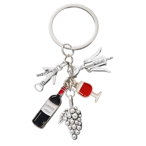 Detailed close-up of wine-themed keychain with grape, bottle, and glass pendants