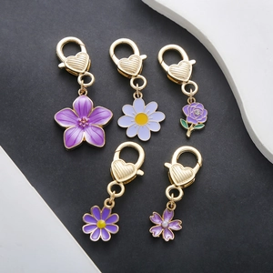 Purple flower keychain set with golden lobster clasps in various floral designs
