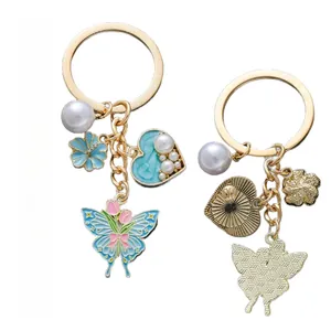 Front and back view of a blue heart pearl keychain with butterfly and rose charms
